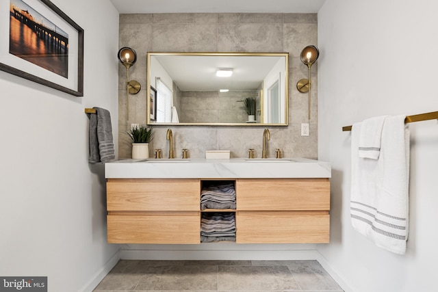 bathroom featuring a tile shower, vanity, and tile patterned floors