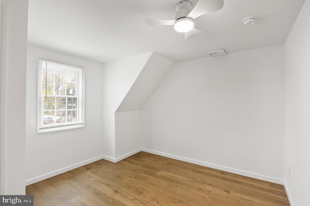 additional living space with ceiling fan and light hardwood / wood-style flooring