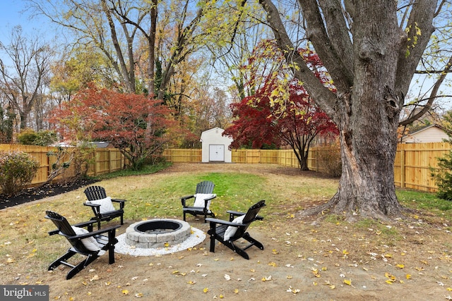 view of yard featuring a storage unit and an outdoor fire pit