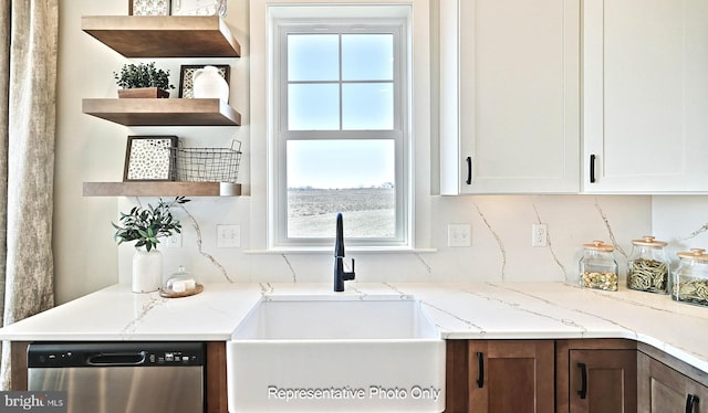 kitchen featuring sink, white cabinetry, dishwasher, and a wealth of natural light