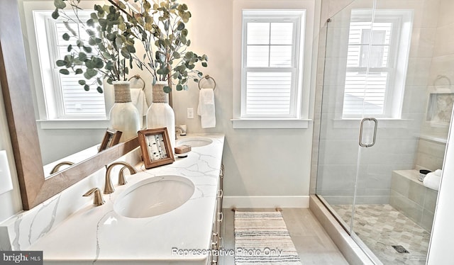 bathroom featuring vanity and a shower with shower door