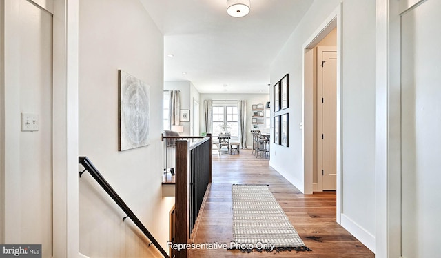 corridor with hardwood / wood-style floors