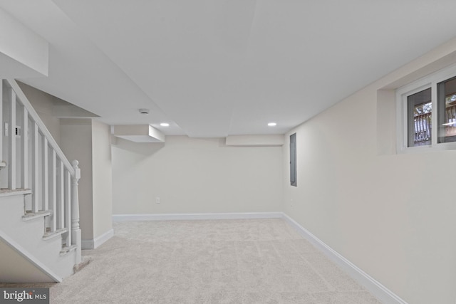 basement featuring light colored carpet