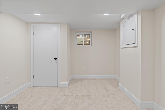 basement featuring light colored carpet