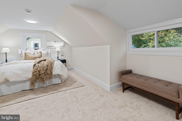 bedroom featuring light carpet and lofted ceiling