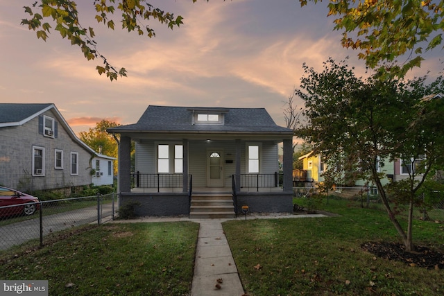 bungalow featuring a yard and covered porch