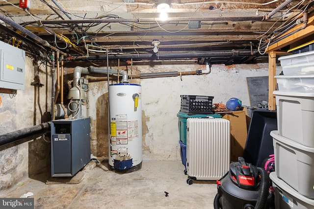 utility room with gas water heater and electric panel