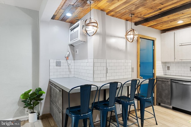 kitchen with dishwasher, light hardwood / wood-style flooring, pendant lighting, white cabinets, and tasteful backsplash