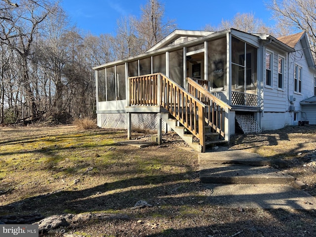 rear view of house featuring a sunroom