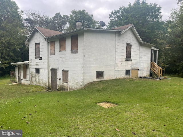 view of property exterior featuring a lawn