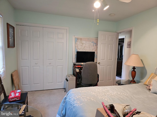 bedroom with light colored carpet and a closet