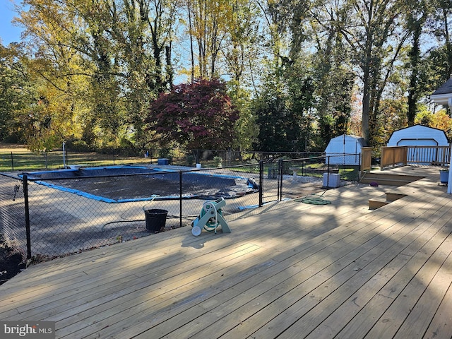 wooden terrace featuring a shed