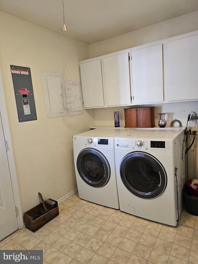 laundry room featuring cabinets, electric panel, and independent washer and dryer