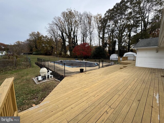 wooden terrace featuring a covered pool