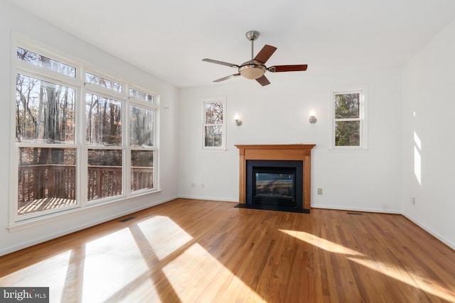 unfurnished living room featuring hardwood / wood-style flooring and ceiling fan