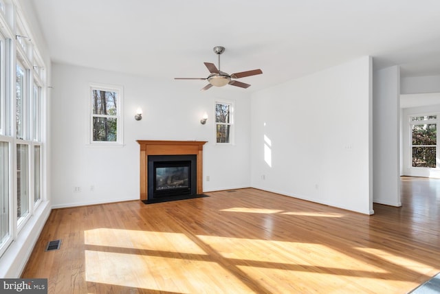 unfurnished living room with hardwood / wood-style floors and ceiling fan