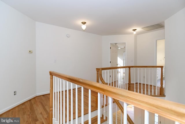 corridor with hardwood / wood-style flooring