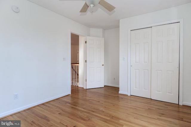 unfurnished bedroom with ceiling fan, a closet, and light hardwood / wood-style floors