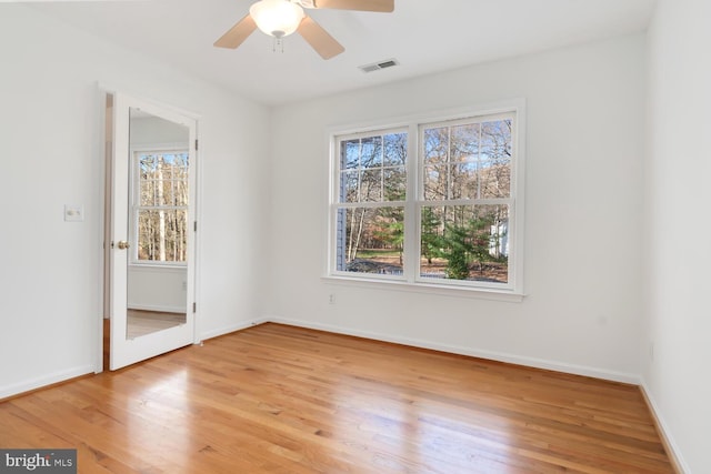 empty room featuring ceiling fan and hardwood / wood-style floors