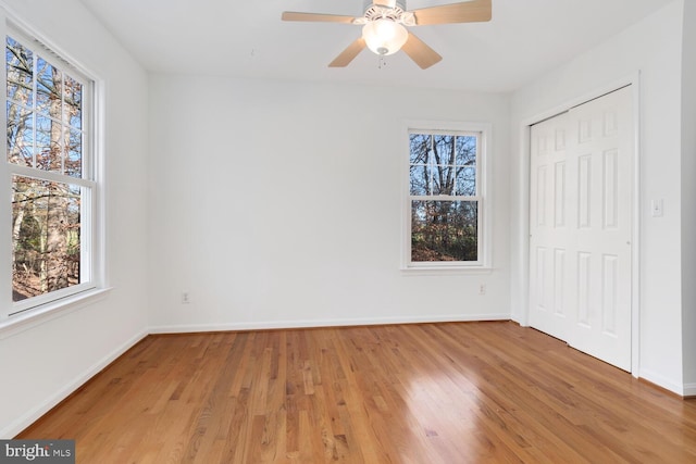 unfurnished bedroom with ceiling fan and light hardwood / wood-style floors