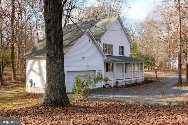 view of front of property featuring a garage and covered porch