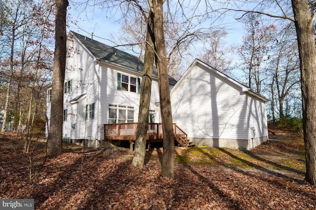 rear view of property with a wooden deck