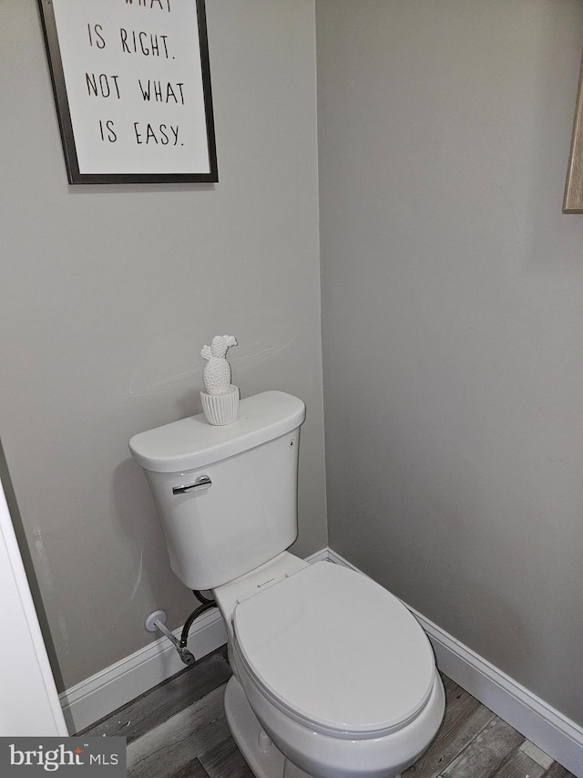 bathroom featuring wood-type flooring and toilet