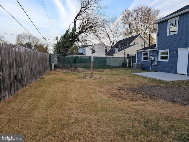 view of yard featuring a patio area and central air condition unit