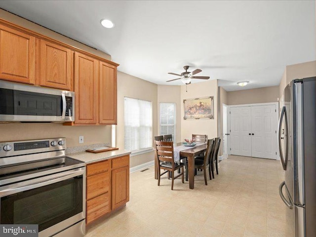 kitchen featuring ceiling fan and stainless steel appliances