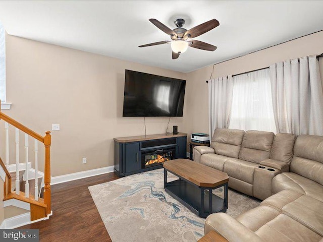 living room with dark hardwood / wood-style floors and ceiling fan