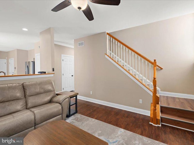 living room with dark wood-type flooring and ceiling fan