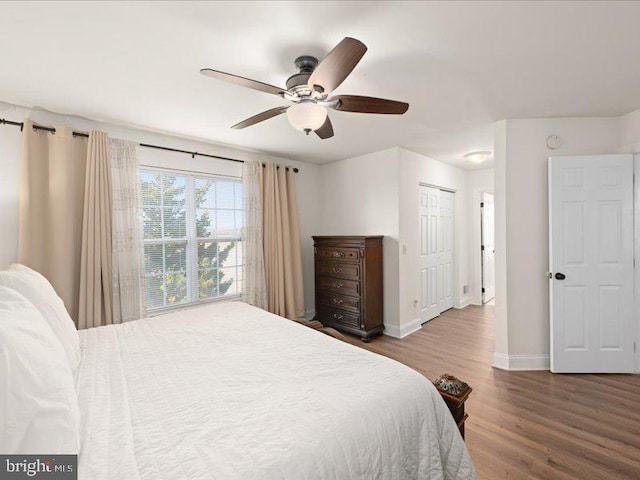 bedroom with wood-type flooring, a closet, and ceiling fan