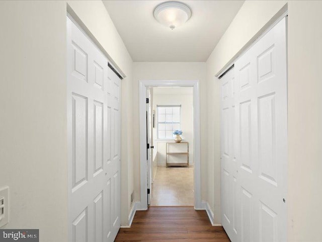 hallway with dark wood-type flooring