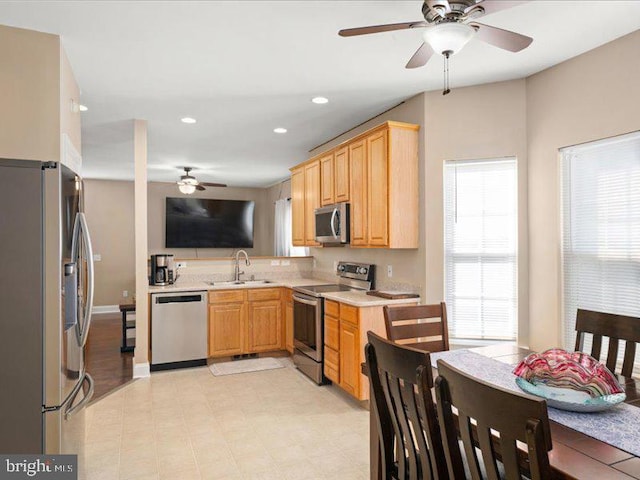 kitchen with sink, appliances with stainless steel finishes, and ceiling fan