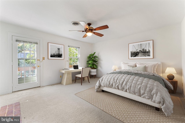 bedroom featuring ceiling fan, multiple windows, carpet floors, and access to exterior