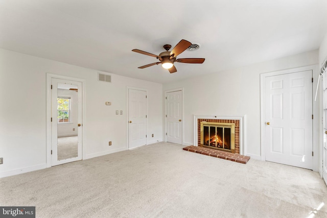 unfurnished living room featuring light carpet, a fireplace, and ceiling fan