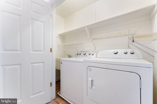 clothes washing area with separate washer and dryer