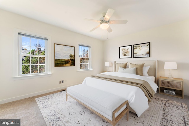 bedroom featuring ceiling fan and light carpet