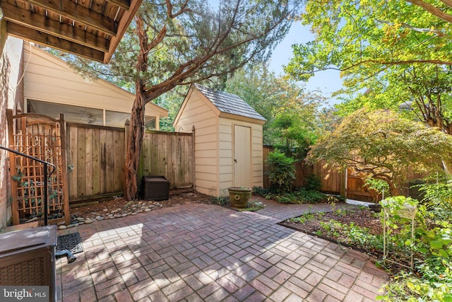 view of patio / terrace featuring a storage unit