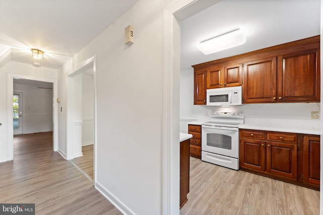 kitchen featuring light hardwood / wood-style flooring and white appliances