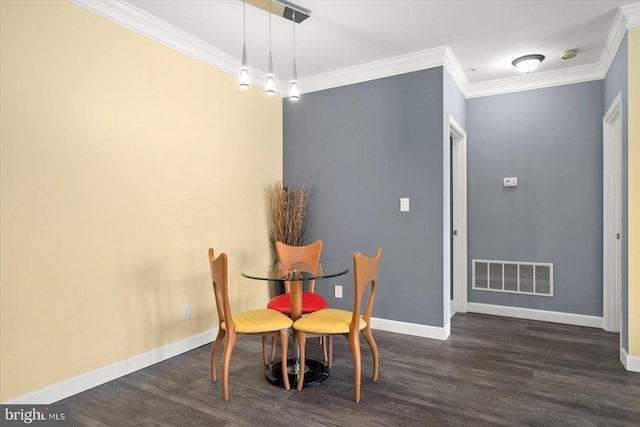 dining space with crown molding and dark wood-type flooring