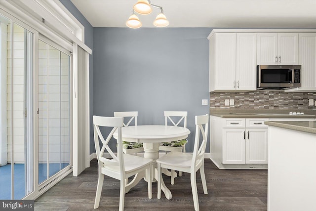 dining space featuring a chandelier and dark hardwood / wood-style flooring