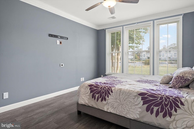 bedroom featuring dark hardwood / wood-style flooring, ornamental molding, and ceiling fan