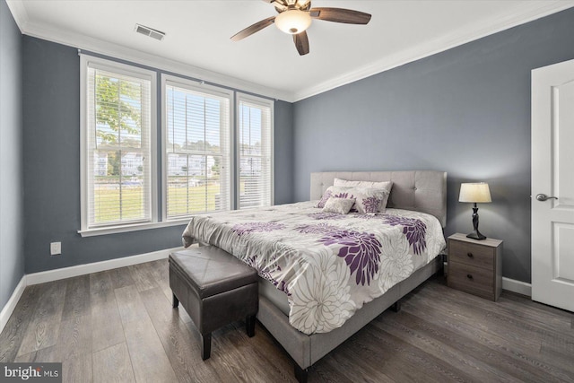 bedroom featuring dark wood-type flooring, ceiling fan, and ornamental molding