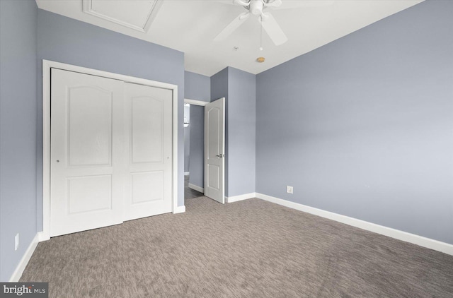 unfurnished bedroom with dark carpet, a closet, and ceiling fan