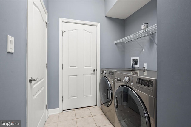 washroom featuring independent washer and dryer and light tile patterned floors