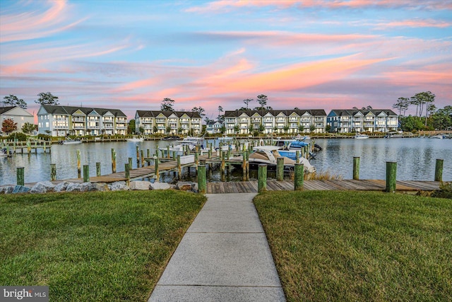 dock area featuring a water view and a yard