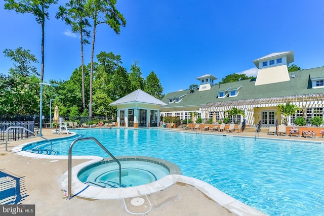 view of swimming pool featuring a patio and a community hot tub