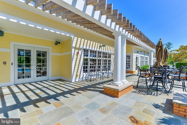 view of patio / terrace featuring french doors and a pergola