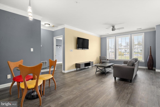 living room featuring ceiling fan, ornamental molding, and dark hardwood / wood-style floors